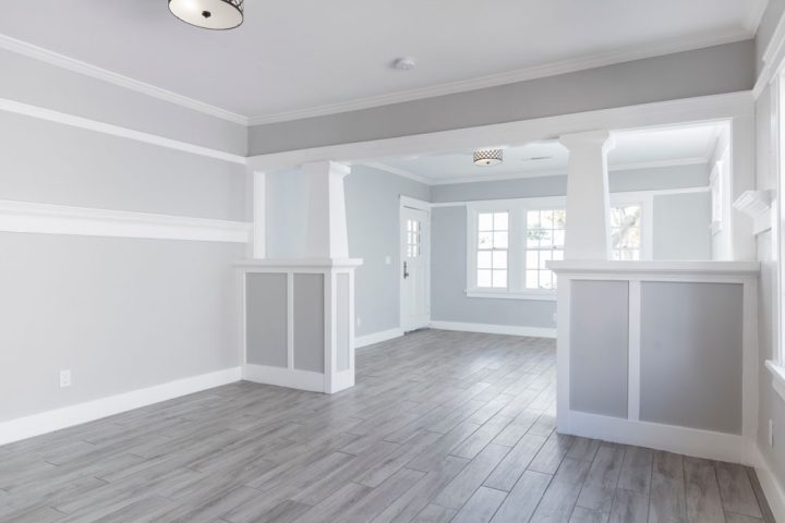a living room with white and gray wall paintings, luxury vinyl plank floor