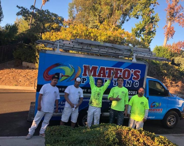 Mateo's happy team standing beside their truck