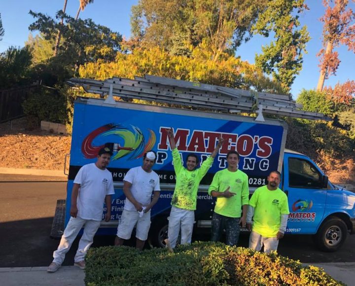 Mateo's happy team standing beside their truck