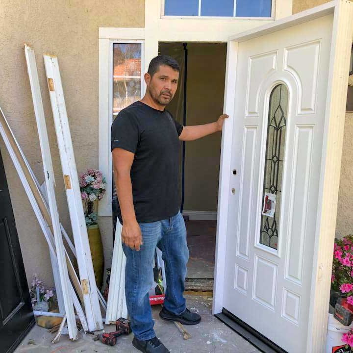 Mateo checking a door after being replaced and painted
