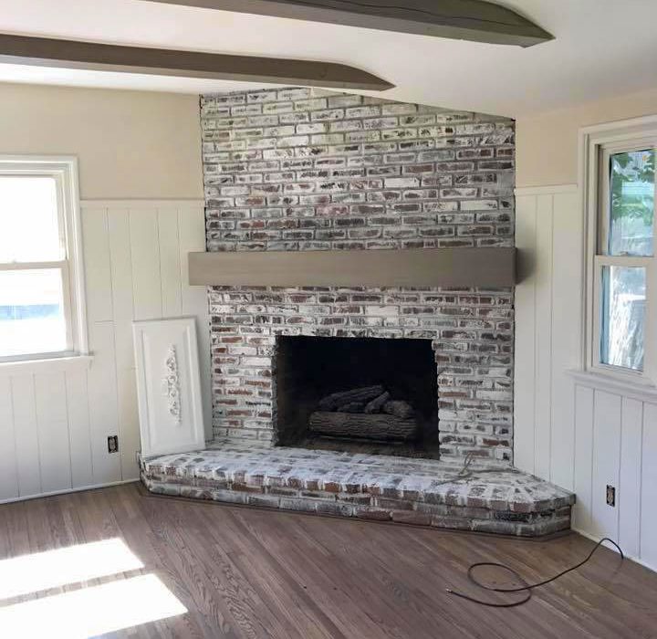 walls and window trims of a house beside the corner fireplace painted with white