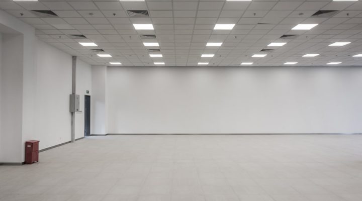 an empty clean room with white painted walls, all ceiling lights are open